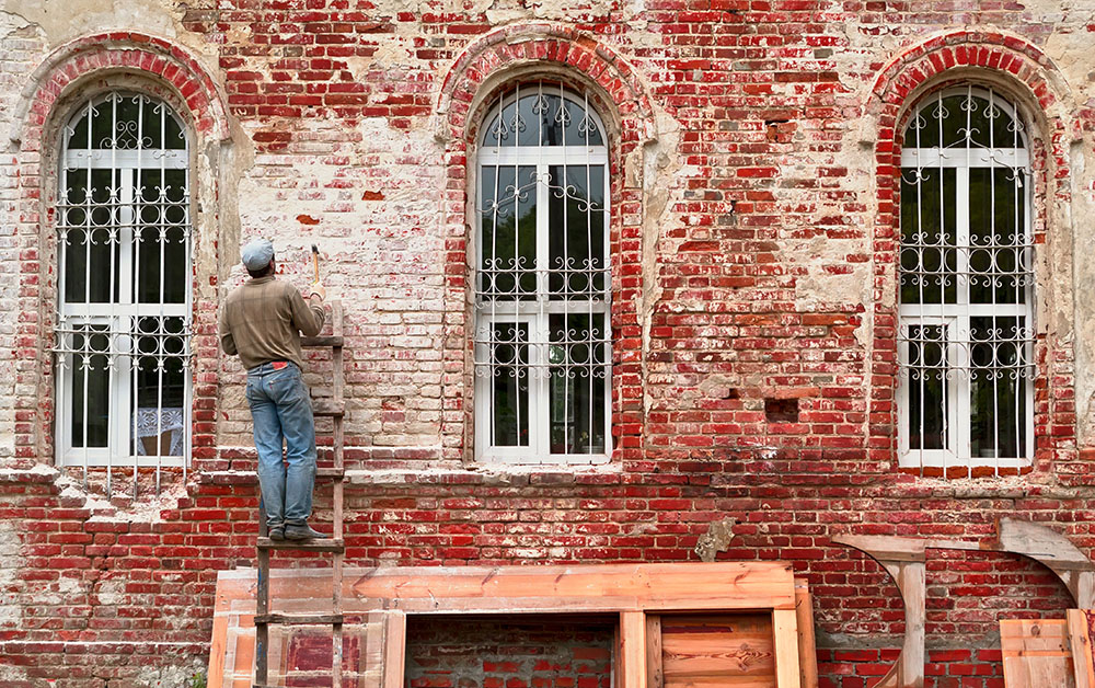 Construction worker works on a historic building